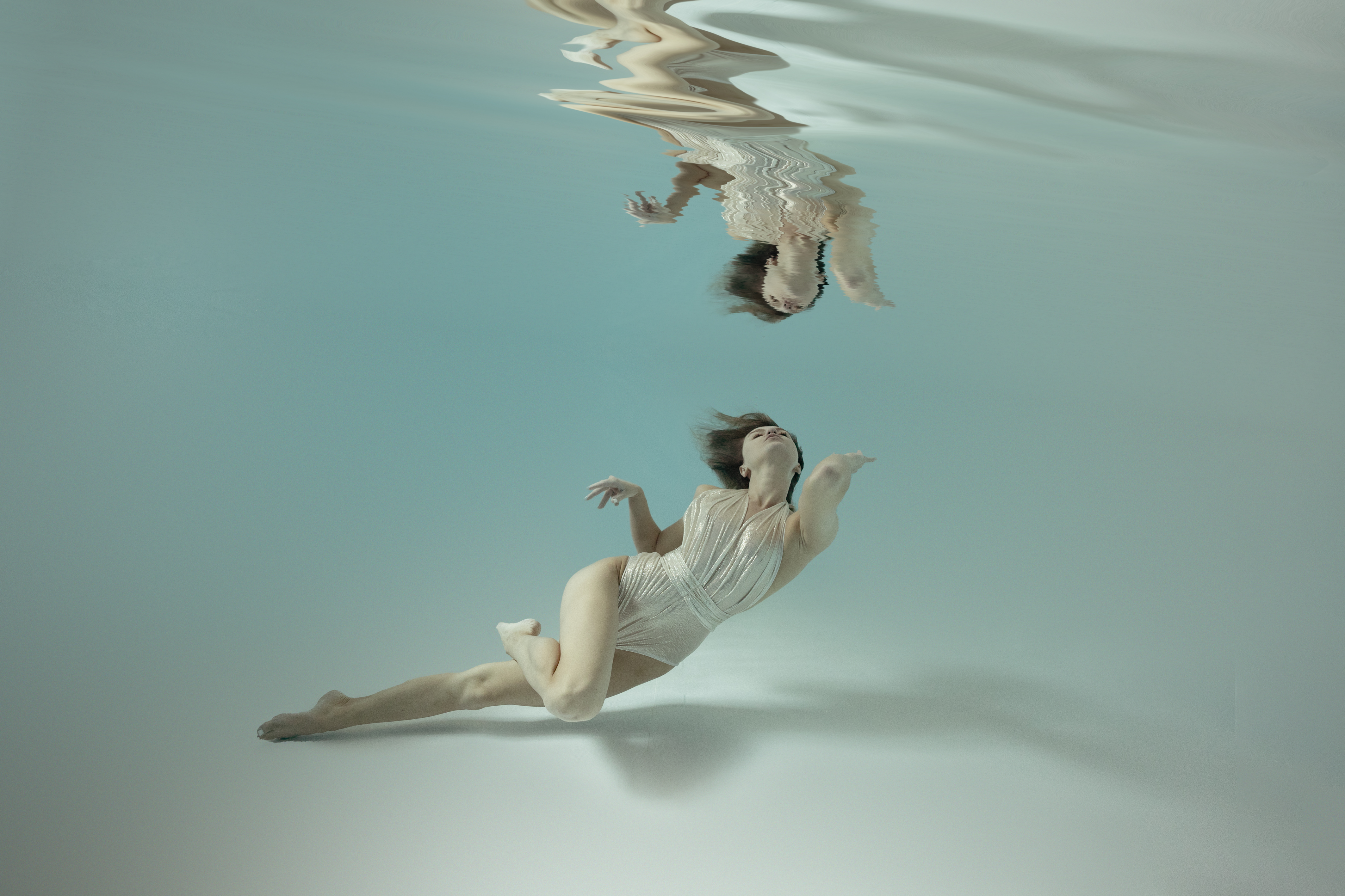 Unterwasserfotografie mit schwebender Pose in blauem Licht